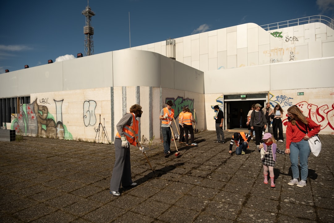 group-of-people-cleaning-up-graffiti-outside-building-1zoatkevaz4